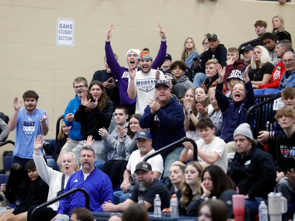 Morgan fans cheer after senior Logan Niceswanger won the 190-pound title at the Division II district wrestling tournament on Saturday at Gallia Academy High School in Gallipolis.