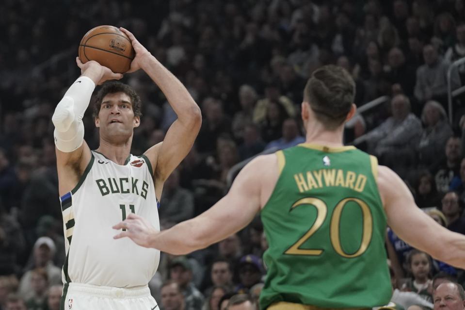 Milwaukee Bucks' Brook Lopez shoots a three-point basket in front of Boston Celtics' Gordon Hayward during the first half of an NBA basketball game Thursday, Jan. 16, 2020, in Milwaukee. (AP Photo/Morry Gash)