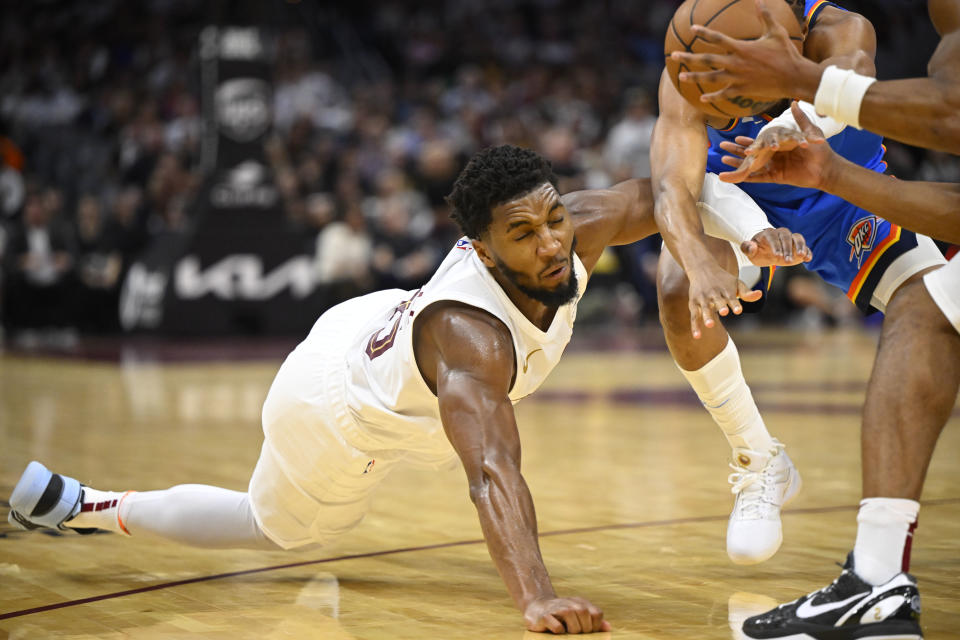 Oct 27, 2023; Cleveland, Ohio, USA; Cleveland Cavaliers guard Donovan Mitchell (45) reaches for a loose ball in the fourth quarter against the Oklahoma City Thunder at Rocket Mortgage FieldHouse. Mandatory Credit: David Richard-USA TODAY Sports