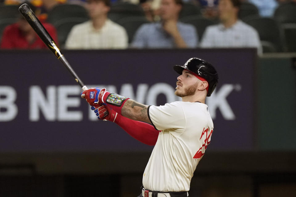 Texas Rangers' Jonah Heim watches his solo home run during the fourth inning of a baseball game against the Houston Astros in Arlington, Texas, Friday, June 30, 2023. (AP Photo/LM Otero)