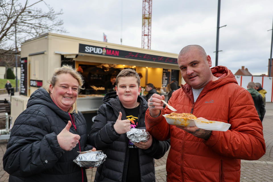 L-R Kathryn Mangles, Zak, and Steven Deere customers from Nottinghamshire with jacket potatoes. (SWNS)