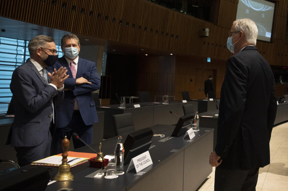 European Commission's Head of Task Force for Relations with the United Kingdom Michel Barnier, right, speaks with Minister of State for Europe at the German Federal Foreign Office Michael Roth, left, and European Commissioner for Inter-institutional Relations and Foresight Maros Sefcovic during a meeting of EU General Affairs ministers at the European Council building in Luxembourg, Tuesday, Oct. 13, 2020. European Commission's Head of Task Force for Relations with the United Kingdom Michel Barnier will brief ministers on the state of play in EU-UK Brexit negotiations ahead of a key EU summit on Thursday. (AP Photo/Virginia Mayo, Pool)