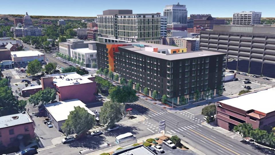 This rendering shows a proposed seven-story apartment building with ground floor commercial space, in center. The proposed new downtown YMCA is at left while a 15-story building can be seen just behind. The Idaho State Capitol is at far upper left. GBD Architects / Pivot North Architecture