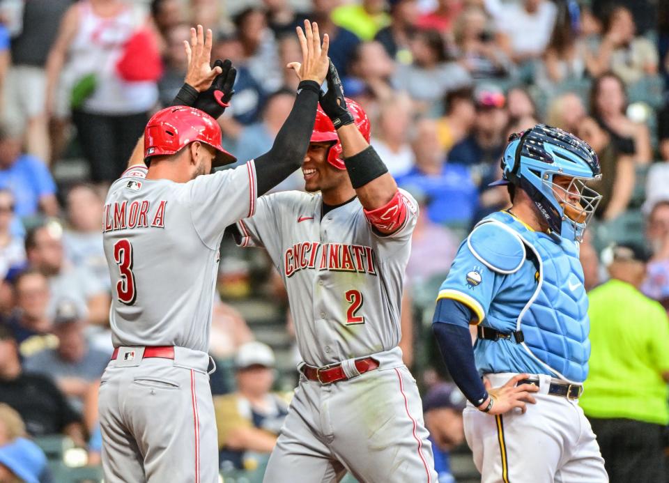 Aug 6, 2022; Milwaukee, Wisconsin, USA;  Cincinnati Reds shortstop Jose Barrero (2) is greeted by left fielder Albert Almora Jr. (3) after hitting a two-run home run in the fourth inning as Milwaukee Brewers catcher Victor Caratini (7) looks on at American Family Field. Mandatory Credit: Benny Sieu-USA TODAY Sports