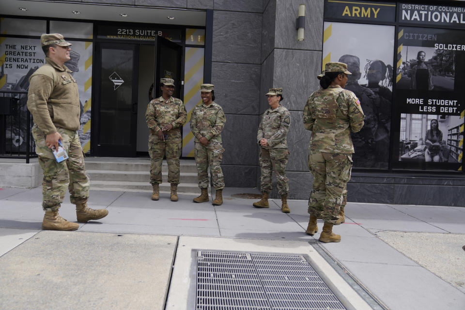The U.S. Army National Guard members stand outside the Army National Guard office during training, Thursday, April 21, 2022 in Washington. In March the local guard opened its first proper recruiting office in the city since 2010. The commander, Maj. Gen. Sherrie McCandless, describes the move as a new push for visibility and an emphasis on the guard’s local connections at a time when many residents might be ripe for recruitment. (AP Photo/Mariam Zuhaib)