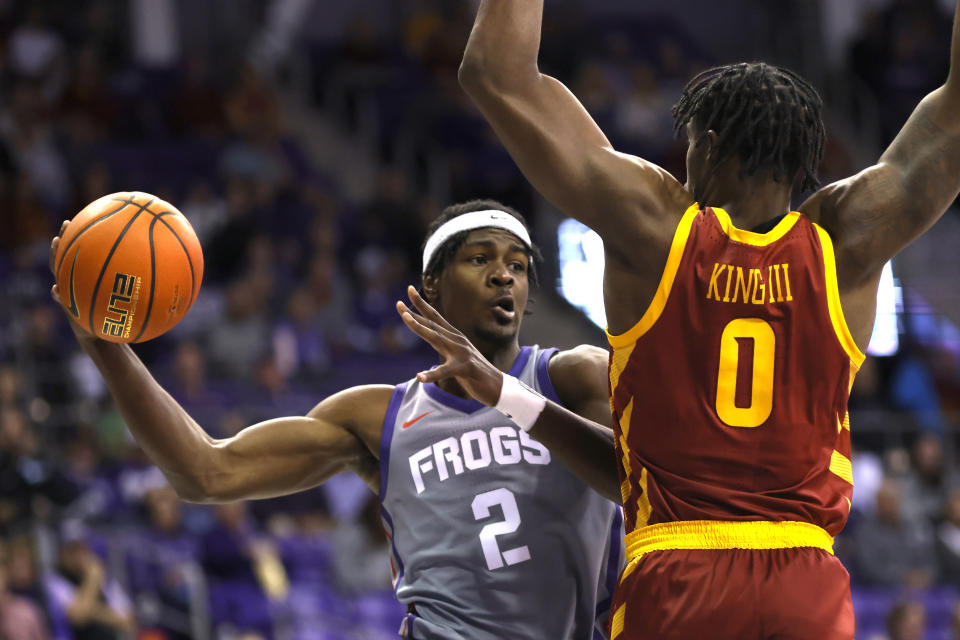 TCU forward Emanuel Miller (2) looks to pass around Iowa State forward Tre King (0) during the first half of an NCAA college basketball game, Saturday, Jan. 7, 2023, in Fort Worth, Texas. (AP Photo/Ron Jenkins)