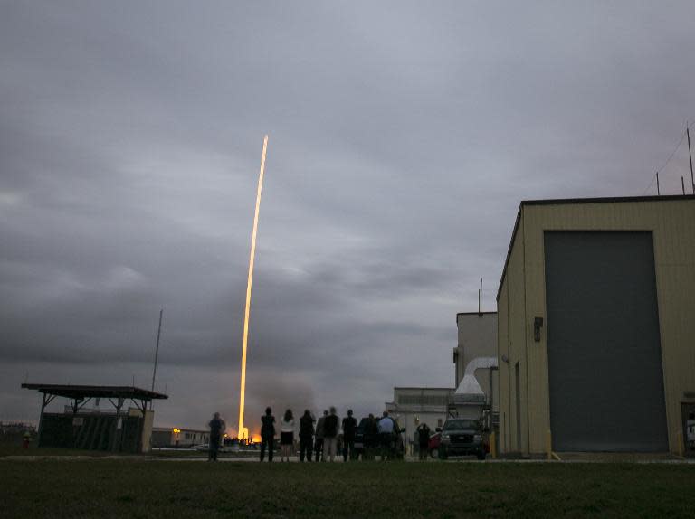Orion team members watch the United Launch Alliance Delta IV Heavy rocket with the Orion spacecraft lift off from Cape Canaveral on December 5, 2014, in Florida
