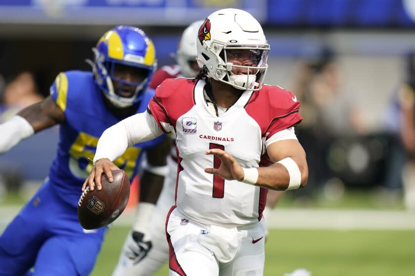 Arizona Cardinals quarterback Kyler Murray rolls out during the first half.