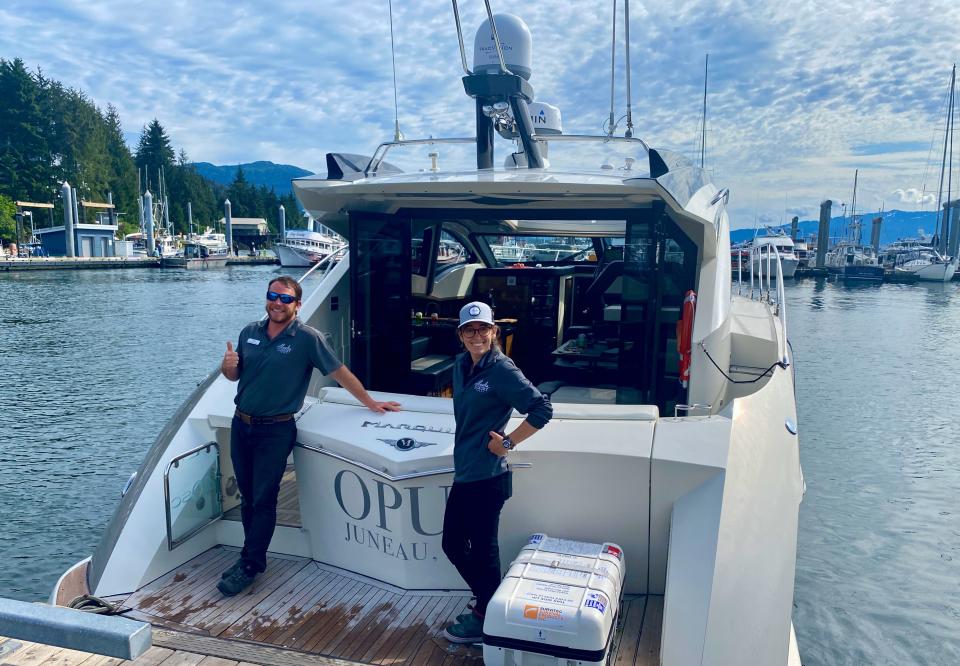 Two crew members on a luxury yacht.