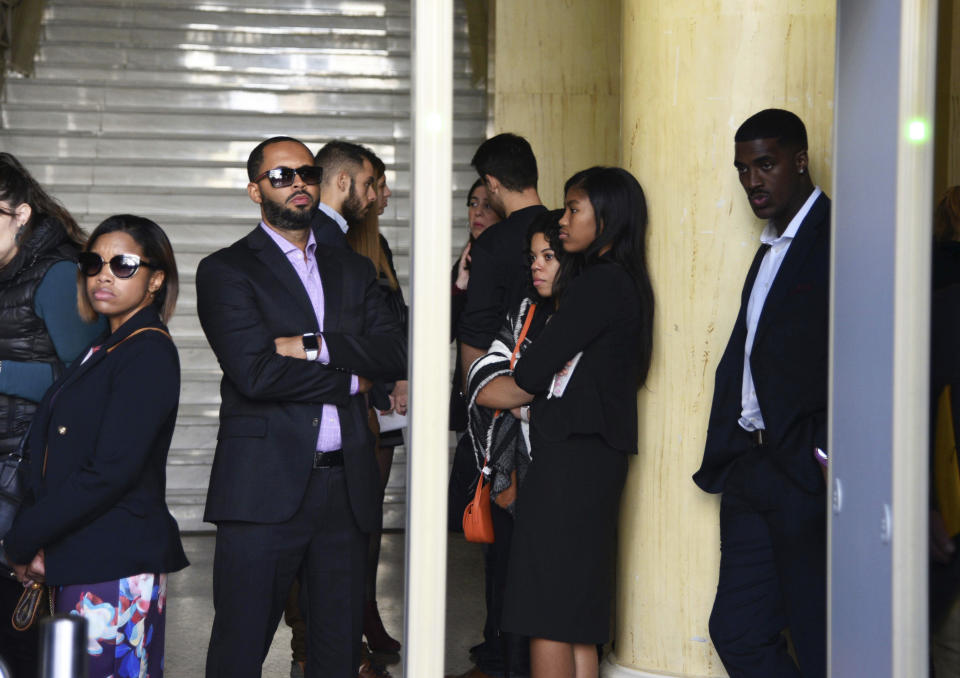 Relatives of Bakari Henderson, an American tourist who was fatally beaten last year year, stand inside a court house in Patras, Greece, Thursday, Nov. 22, 2018. A Greek court on Thursday convicted and sentenced six of nine suspects in the fatal beating of Henderson, who died after being beaten in the street following an argument in a bar in the popular Laganas resort area of Zakynthos island in July 2017. (AP Photo/Giannis Androutsopoulos)