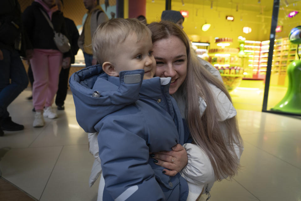 Kateryna Dmytryk hugs her 2-year-old son, Timur, in Kyiv, Ukraine, on Feb. 9, 2024, as she waits for her husband, Artem, who was released as a part of a prisoner swap. (AP Photo/Vasilisa Stepanenko)