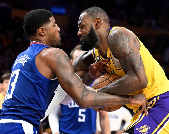 Los Angeles, California October 20, 2022-Lakers LeBron James gets fouled by Clippers Paul George.