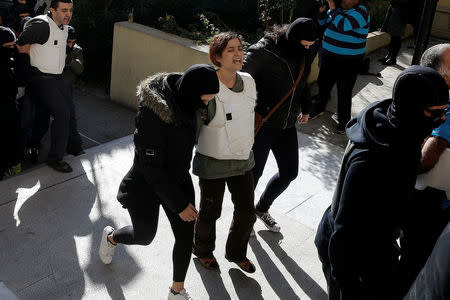 Eight men and a woman holding Turkish citizenship, who were arrested on suspected links to a leftist militant group outlawed in Turkey following an operation by Greek security services, are escorted by anti-terrorism police officers to the prosecutor's office in Athens, Greece, November 29, 2017. REUTERS/Alkis Konstantinidis