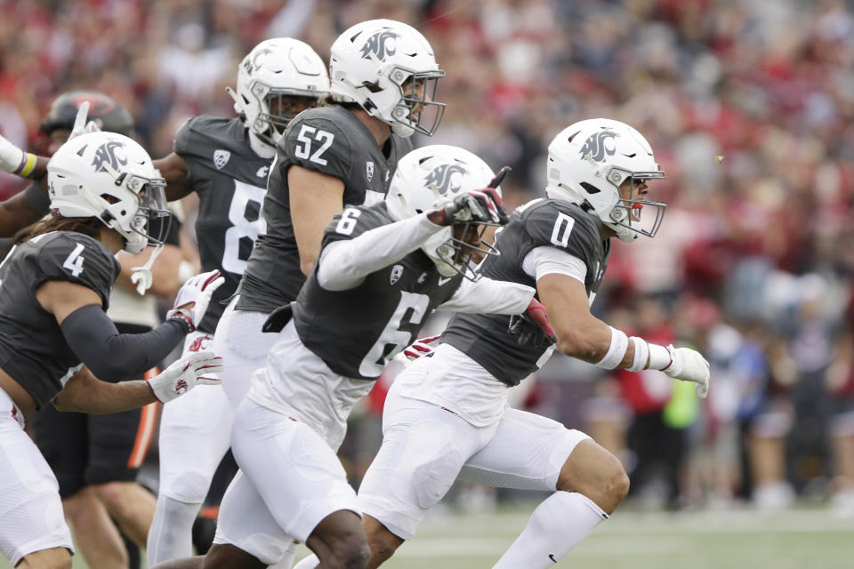 Washington State defensive back Sam Lockett III (0) celebrates intercepting an Oregon State pass with teammates during the first half of an NCAA college football game, Saturday, Sept. 23, 2023, in Pullman, Wash. (AP Photo/Young Kwak)