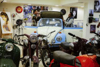 Workers clean a1963 Volkswagen Beetle at a private collector's garage in Obour city, near Cairo, Egypt, March 1, 2022. In more than 20 years, the 52 years-old businessman managed to collect a fleet of around 250 vintage, classic and Modern-Classic cars. (AP Photo/Amr Nabil)