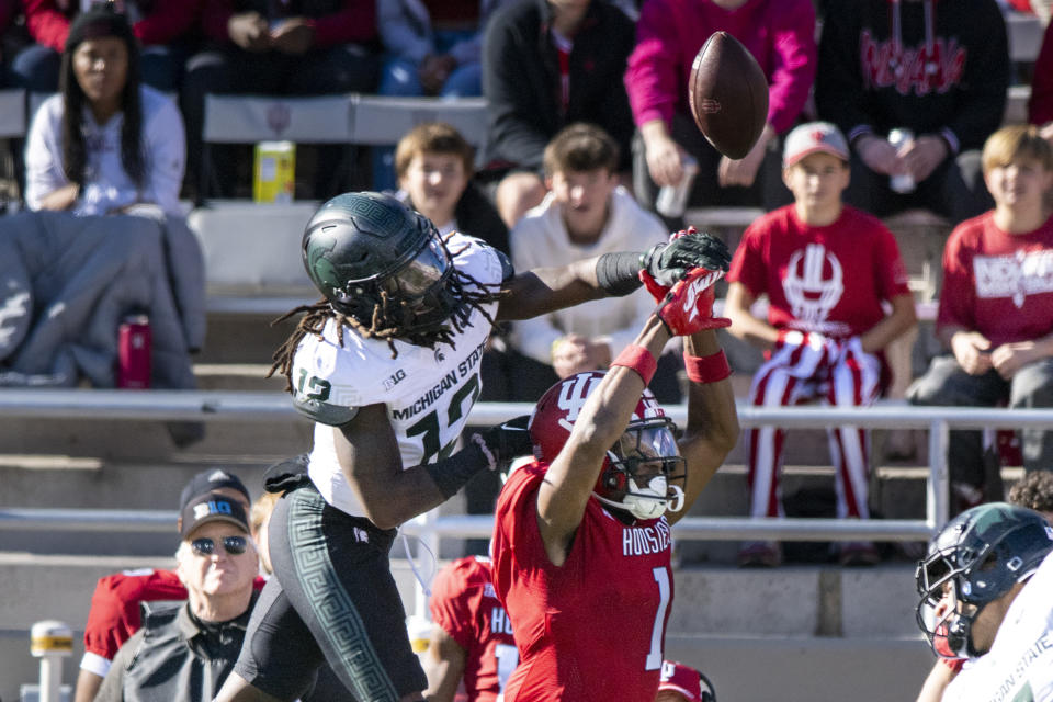 Michigan State defensive back Chester Kimbrough (12) breaks up a pass intended for Indiana wide receiver Donaven McCulley (1) during an NCAA college football game, Saturday, Nov. 18, 2023, in Bloomington, Ind. (AP Photo/Doug McSchooler)