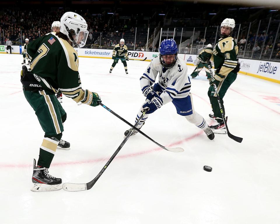 Scituate’s Johnny Donahue and Nashoba Regional's Colin Ruschioni vie for the puck during second period action of their game against Nashoba Regional in the Division 3 state title game at the TD Garden on Sunday, March 19, 2023. Scituate fell to Nashoba Regional 2-1 in OT. 