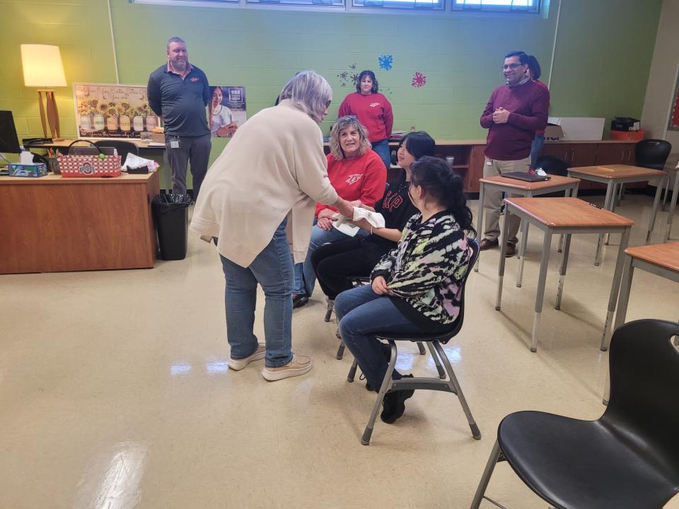 Chris Stone and Sandy Stone deliver Kind Kids Awards to students at Bucyrus City School Secondary Building. The award, which praises kindness, is in honor of Chris's father and Sandy's late husband, Chuck Stone.