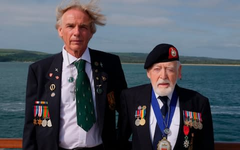 Les Budding, on the rights, tands with Philip Collins, 62, who is the son of the late F.E. Collins of 45 Commando, who fought alongside Budding on D-Day - Credit: AP Photo/Ben Jary