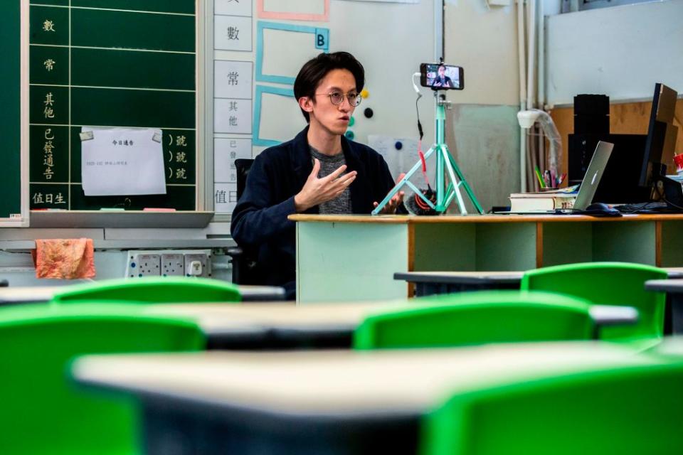 Primary school teacher Billy Yeung records a video lesson for his students who have had their classes suspended in Hong Kong due to the COVID-19. Source: Getty