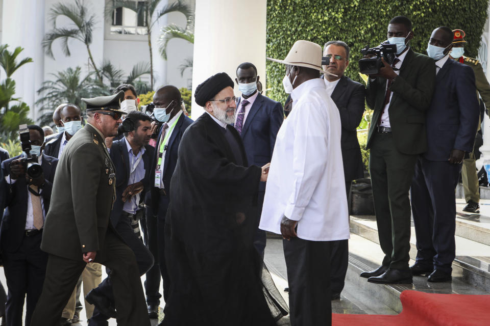 Iran's President Ebrahim Raisi, center-left, shakes hands with Uganda's President Yoweri Museveni, center-right, at State House in Entebbe, Uganda Wednesday, July 12, 2023. Iran's president has begun a rare visit to Africa as the country, which is under heavy U.S. economic sanctions, seeks to deepen partnerships around the world. (AP Photo/Hajarah Nalwadda)