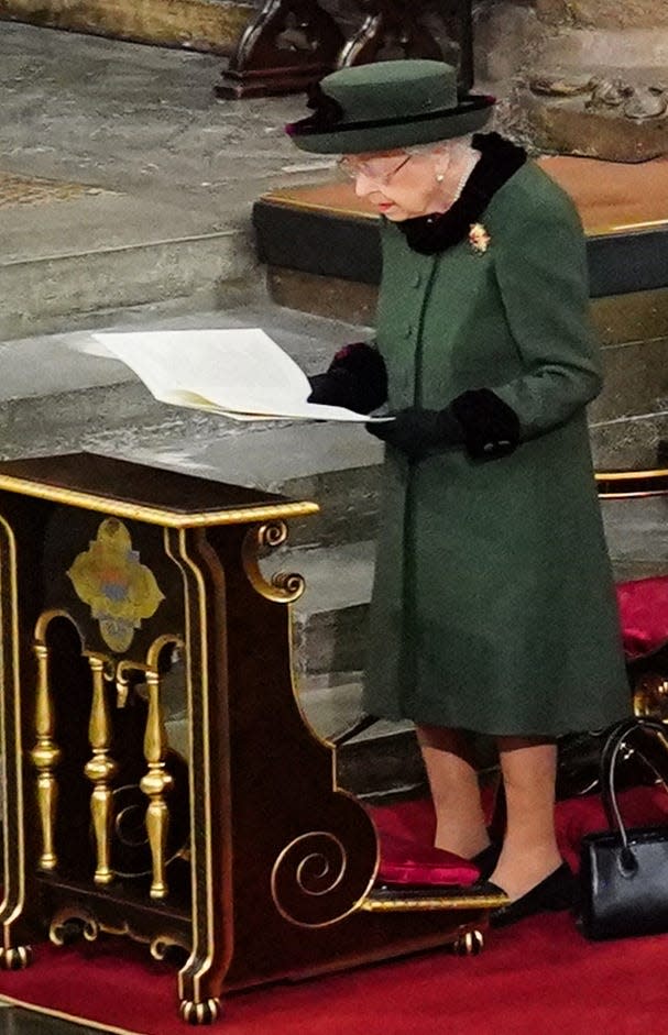 Queen Elizabeth II reading at the service of thanksgiving for her late husband, Prince Philip Duke of Edinburgh, in Westminster Abbey on March 29, 2022.
