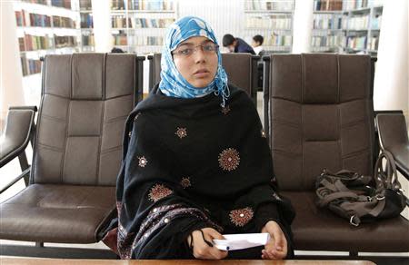 Serena Faizi, 25, one of the provincial candidate elections from Kandahar, sits at a public library in Kandahar province, April 14, 2014. REUTERS/ Ahmad Nadeem