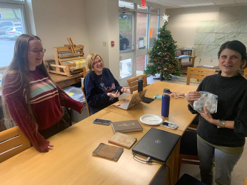From left, Mars Hill University students Megan Walters and Darian Smathers laugh with their shape note singing professor Leila Weinstein, program coordinator of the university's Ramsey Center for Appalachian Studies.