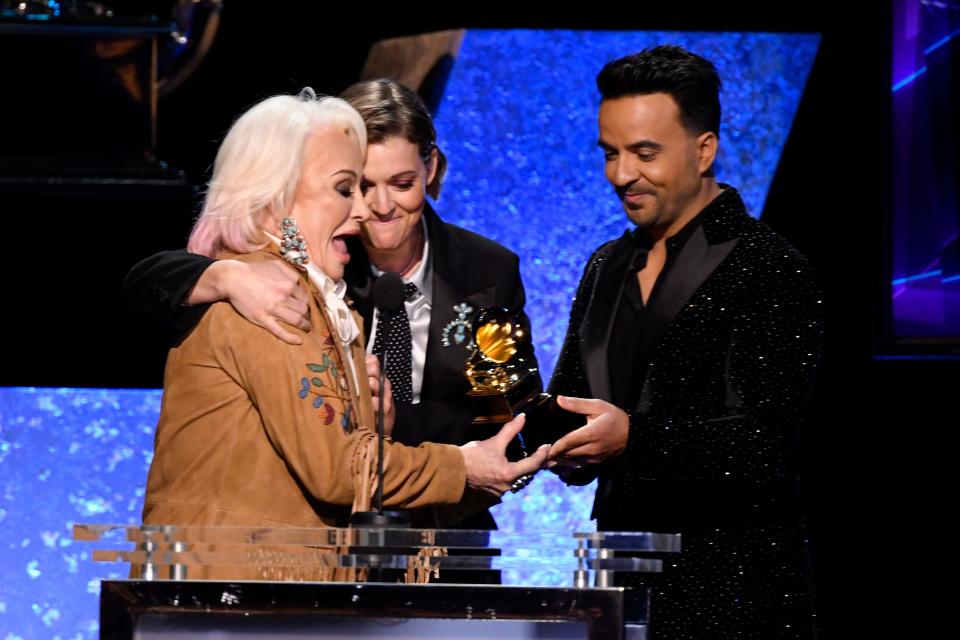 Tanya Tucker (left)  joined by Brandi Carlile (center) accepts the award for best country album is announced for her album "While I'm Livin" from Luis Fonsi during the 62nd annual Grammy Awards.