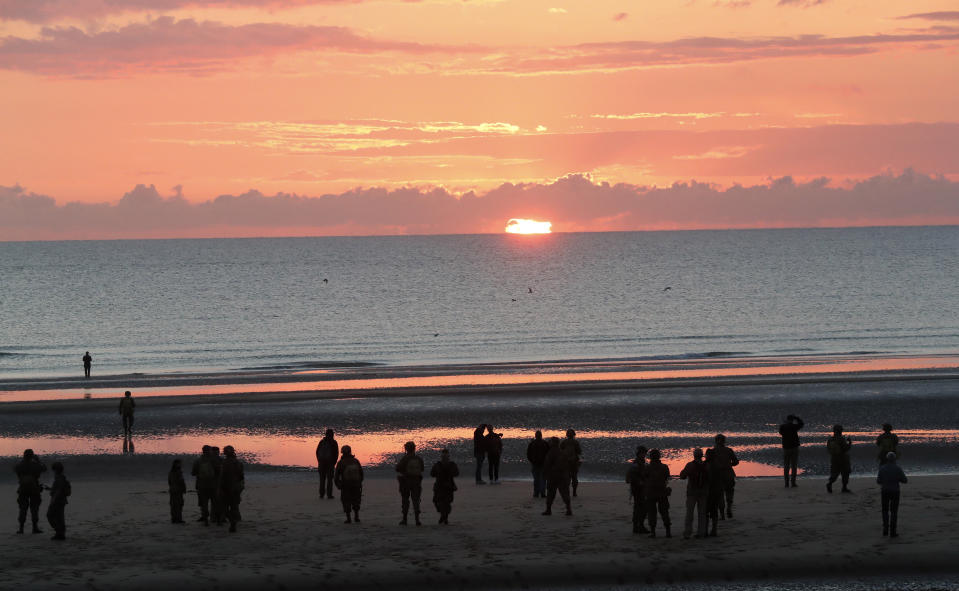 World War II reenactors gather at dawn on Omaha Beach, in Normandy, France, Thursday, June 6, 2019 during commemorations of the 75th anniversary of D-Day. (AP Photo/Thibault Camus)