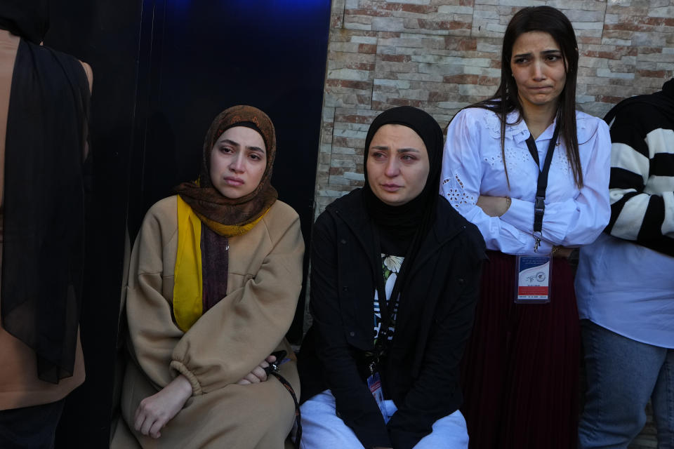 Colleagues of the two slain journalists of pan-Arab TV network Al-Mayadeen, who were killed by an Israeli strike, mourn outside the station's headquarters in Beirut, Lebanon, Tuesday, Nov. 21, 2023. An Israeli strike on southern Lebanon killed Tuesday two journalists reporting for the Beirut-based Al-Mayadeen TV on the violence along the border with Israel, according to the Lebanese information minister and their TV station. (AP Photo/Bilal Hussein)