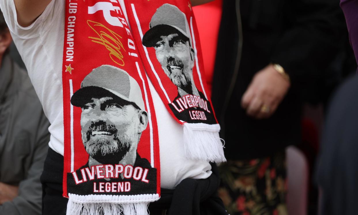 <span>A Liverpool fan wears a Jürgen Klopp scarf in the stands at Anfield, where the manager hopes he won’t be joining them for Wolves’ visit.</span><span>Photograph: Paul Greenwood/Shutterstock</span>