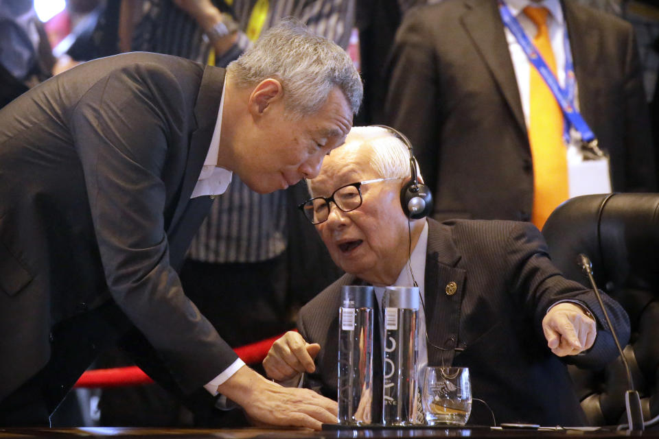 FILE - Singapore's Prime Minister Lee Hsien Loong, left, and Taiwan's envoy Morris Chang, founder of one of the world's largest chip manufacturers TSMC, talk before an informal dialogue session at APEC Haus, Nov. 18, 2018, in Port Moresby, Papua New Guinea. Chang, 91, will once again be Taiwan’s envoy at this week's APEC held in Bangkok, Thailand, Nov. 16-19, 2022. (AP Photo/Mark Schiefelbein, File)