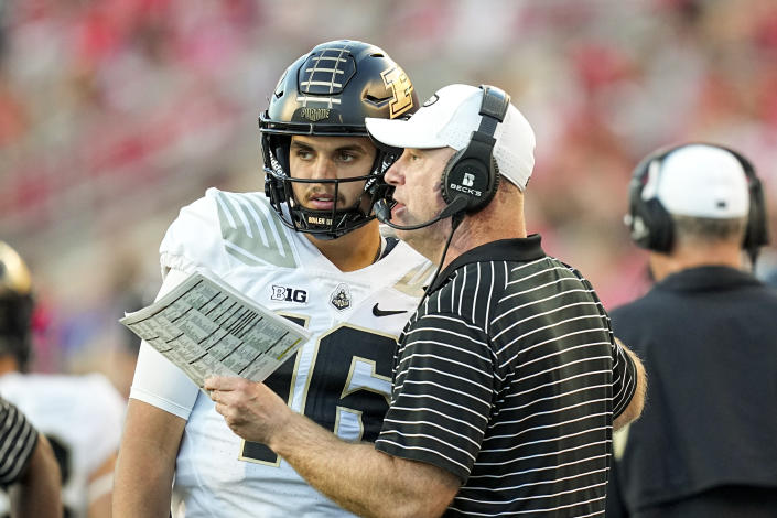 Purdue head coach Jeff Brohm talks with quarterback Aidan O'Connell during the second half of an NCAA college football game Saturday, Oct. 22, 2022, in Madison, Wis. Wisconsin won 35-24. (AP Photo/Andy Manis)