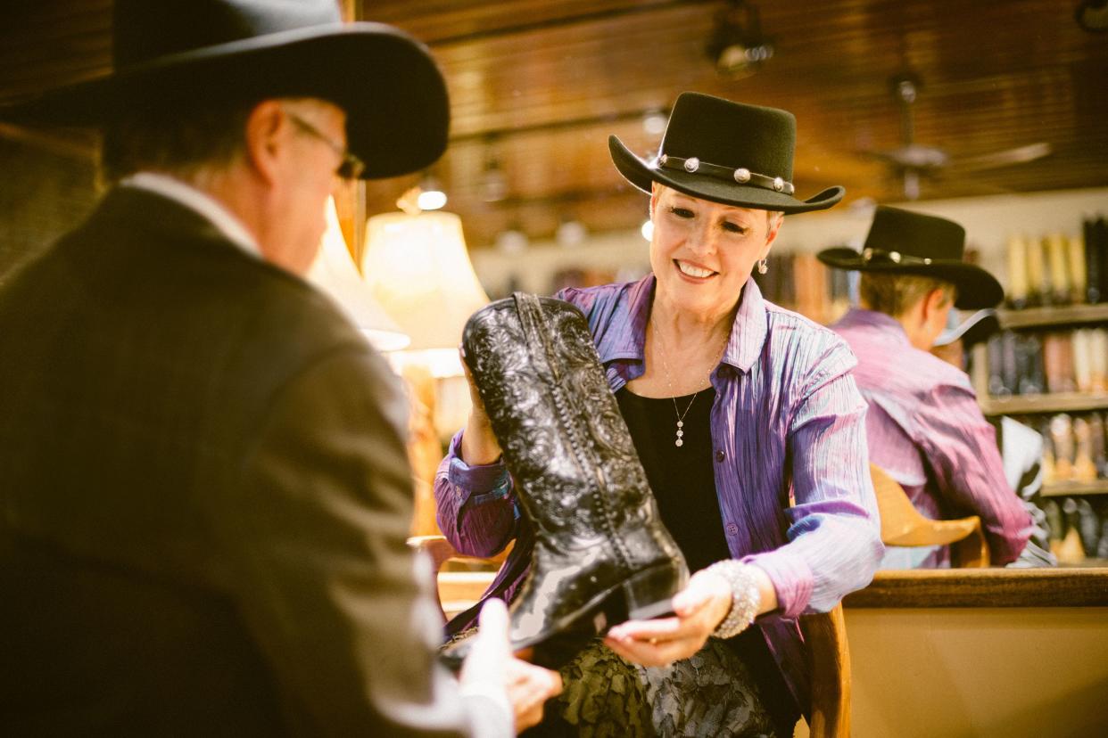 senior woman shopping for cowgirl boots