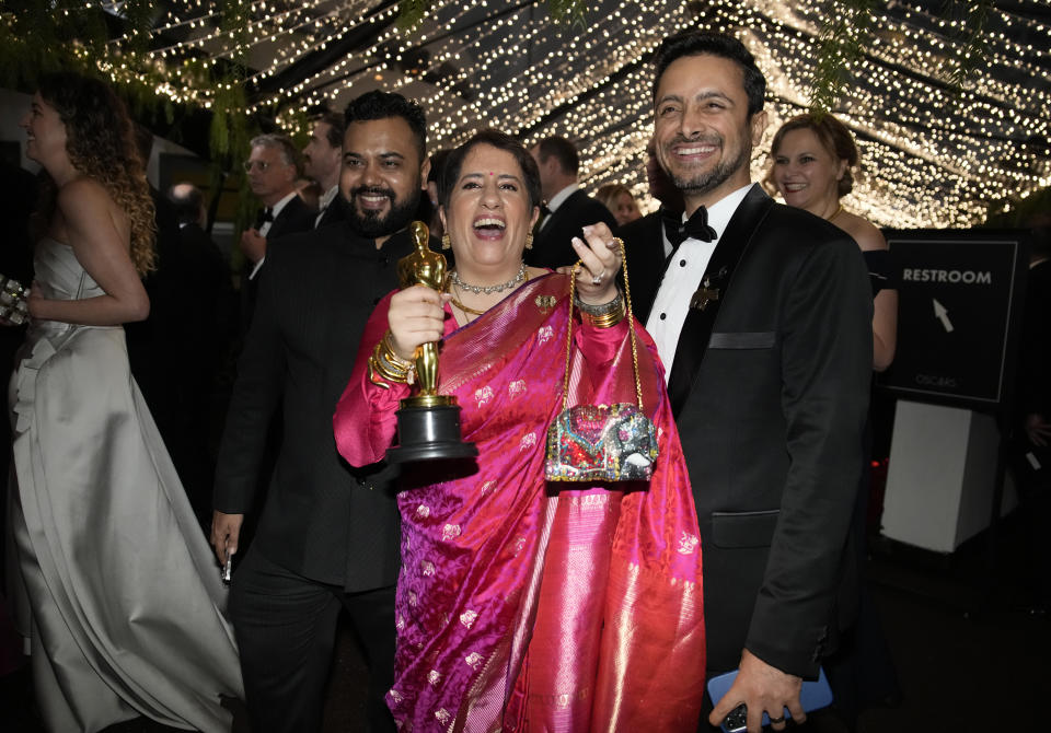 Achin Jain, from left, Guneet Monga and Sunny Kapoor attend the Governors Ball after the Oscars on Sunday, March 12, 2023, at the Dolby Theatre in Los Angeles. Achin Jain and Guneet Monga won the award for best documentary short film for "The Elephant Whisperer." (AP Photo/John Locher)