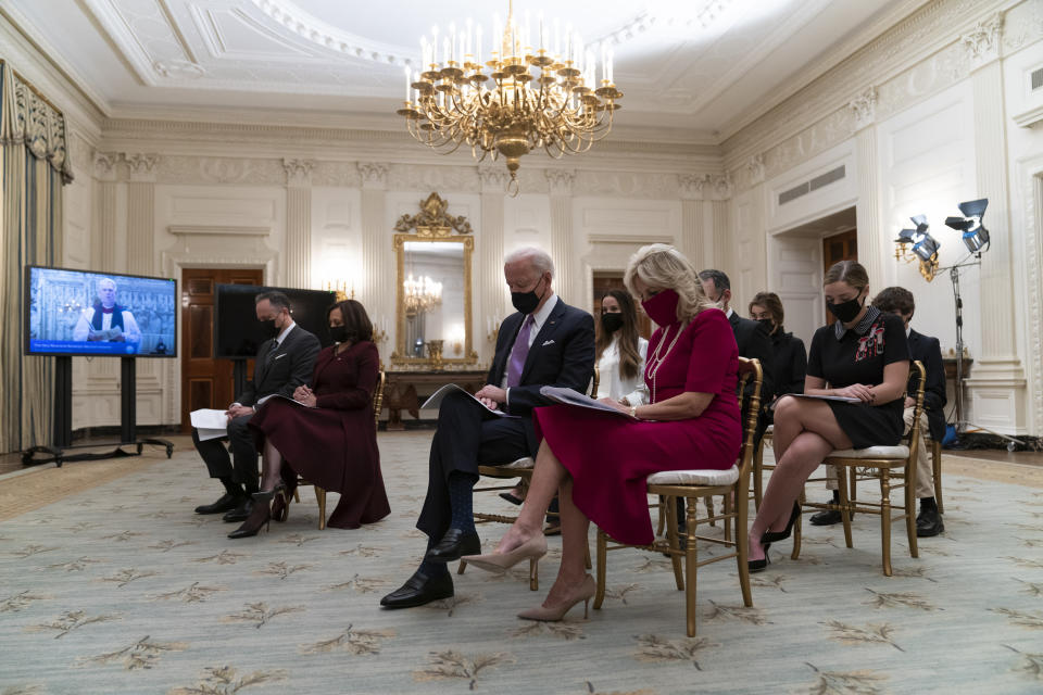 Doug Emhoff, left, Vice President Kamala Harris, President Joe Biden, and first lady Jill Biden, bow their heads in prayer during a virtual Presidential Inaugural Prayer Service, in the State Dinning Room of the White House, Thursday, Jan. 21, 2021, in Washington. (AP Photo/Alex Brandon)