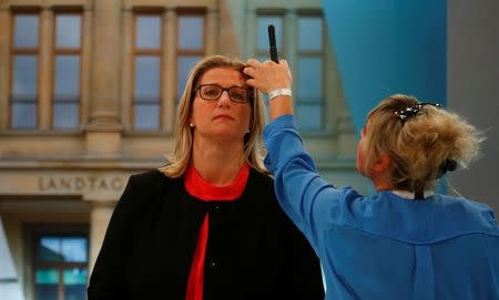 Anke Rehlinger, top candidate of the Social Democratic Party (SPD) receives make-up in a TV studio after first exit polls of the Saarland state elections in Saarbruecken, Germany, March 26, 2017. REUTERS/Ralph Orlowski -