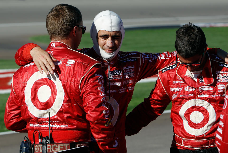 LAS VEGAS, NV - OCTOBER 16: Dario Franchitti, driver of the #10 Target Chip Ganassi Racing Dallara Honda hugs crew members after Dan Wheldon, driver of the #77 Dallara Honda, was killed during the Las Vegas Indy 300 part of the IZOD IndyCar World Championships presented by Honda at Las Vegas Motor Speedway on October 16, 2011 in Las Vegas, Nevada. (Photo by Tom Pennington/Getty Images)