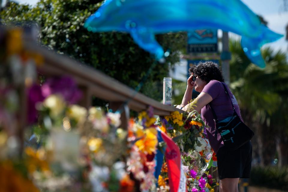 A woman gets emotional after placing flowers at a memorial for the victims of the Conception in the Santa Barbara Harbor on Wednesday, Sept. 4, 2019, in Santa Barbara, California. The fire killed 34 people and the trial against Conception Capt. Jerry Boylan began in federal court in Los Angeles on Tuesday, Oct. 24, 2023.
