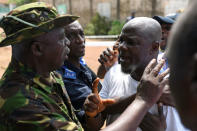 A military member argues with a voter outside a polling station during a presidential run-off in Freetown, Sierra Leone March 31, 2018. REUTERS/Olivia Acland