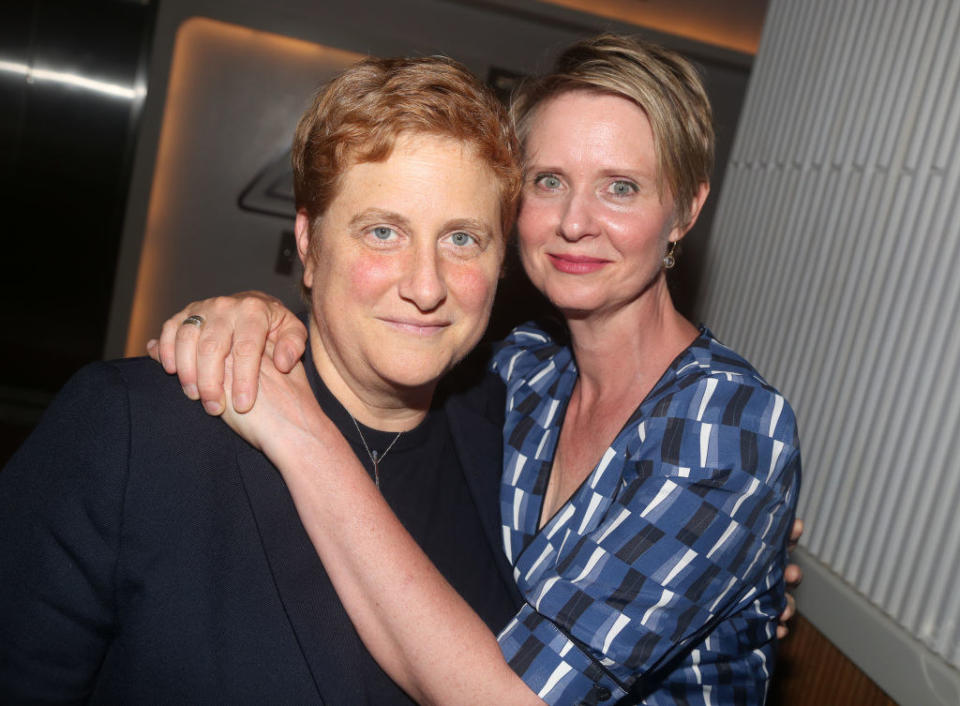 Christine Marinoni and Cynthia Nixon smiling with their arms around each other