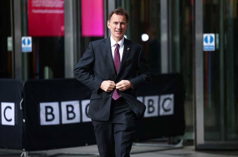 British Chancellor of the Exchequer Jeremy Hunt talks to a television crew outside the BBC headquarters in London