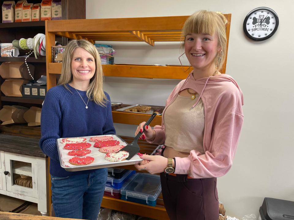 Owner Sonja Hawk with assistant Samantha Hull show off fresh baked Valentine’s cookies made especially for dogs at River Dog Bakery at 11422 Kingston Pike, Jan. 30, 2024.