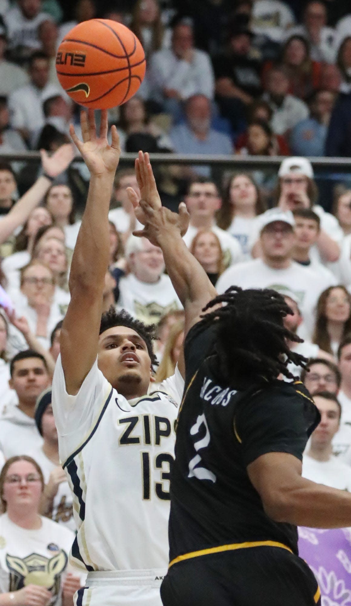 Akron's Xavier Castaneda fires a 3-pointer as Kent State's Malique Jacobs defends at Rhodes Arena in Akron on Friday.
