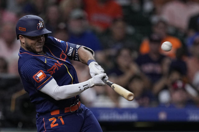 Houston Astros' Jeremy Pena watches his hits an RBI single during