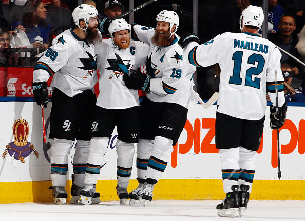 TORONTO, ON - DECEMBER 13: Joe Pavelski #8 of the San Jose Sharks is congratulated by teammates Brent Burns #88, Joe Thornton #19 and Patrick Marleau #12 after evening the score at 2 during the third period at the Air Canada Centre on December 13, 2016 in Toronto, Ontario, Canada. (Photo by Mark Blinch/NHLI via Getty Images)