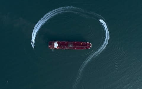 A speedboat of Iran's Revolutionary Guard is photographed moving around the British-flagged oil tanker Stena Impero in the Strait of Hormuz - Credit: Morteza Akhoondi/Tasnim News Agency via AP