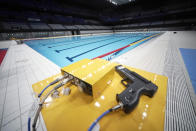 The swimming pool of Tokyo Aquatics Center is seen after a grand opening ceremony Saturday, Oct. 24, 2020, in Tokyo. The Tokyo 2020 organizing committee held the grand opening ceremony Saturday at the aquatics center, planned to host Olympic artistic swimming, diving and swimming and Paralympics swimming events in 2021. (AP Photo/Eugene Hoshiko)