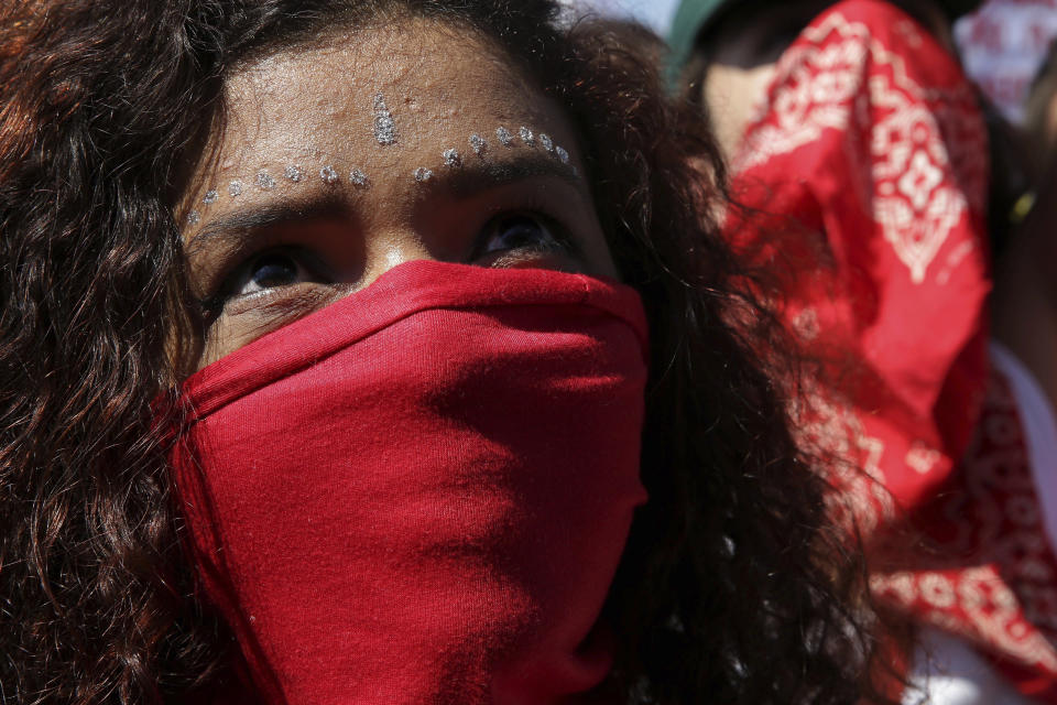 A masked student takes part in a nation-wide education strike, in Brasilia, Brazil, Wednesday, May 15, 2019. Federal education officials this month announced budget cuts of $1.85 billion for public education, part of a wider government effort to slash spending. (AP Photo/Eraldo Peres)